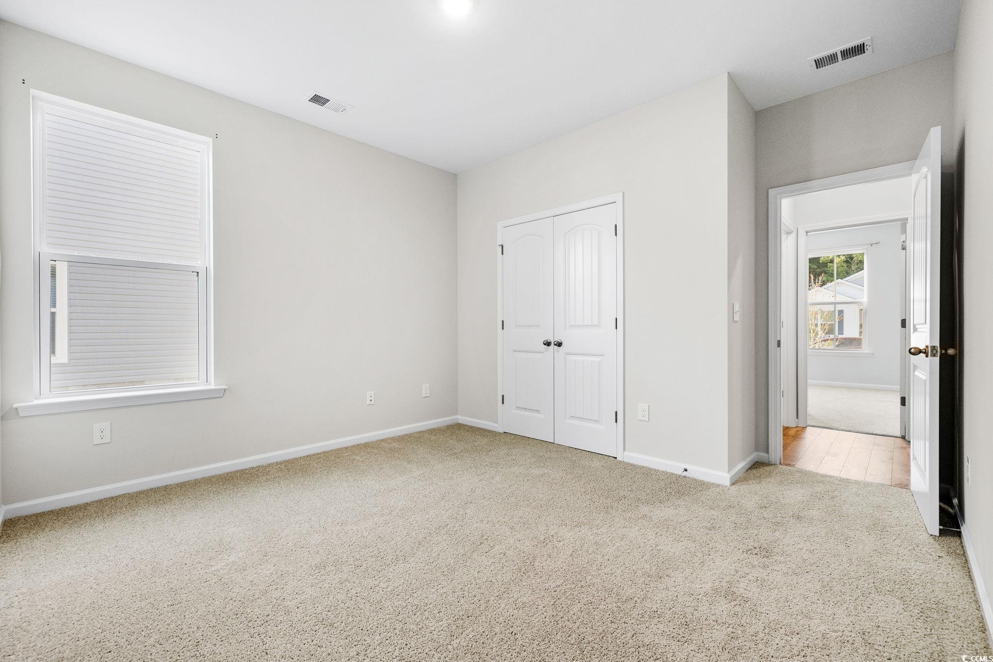 453 Kapalua Loop Little River, SC 29566 - Photo 12 of 27 Unfurnished bedroom with light colored carpet and a closet