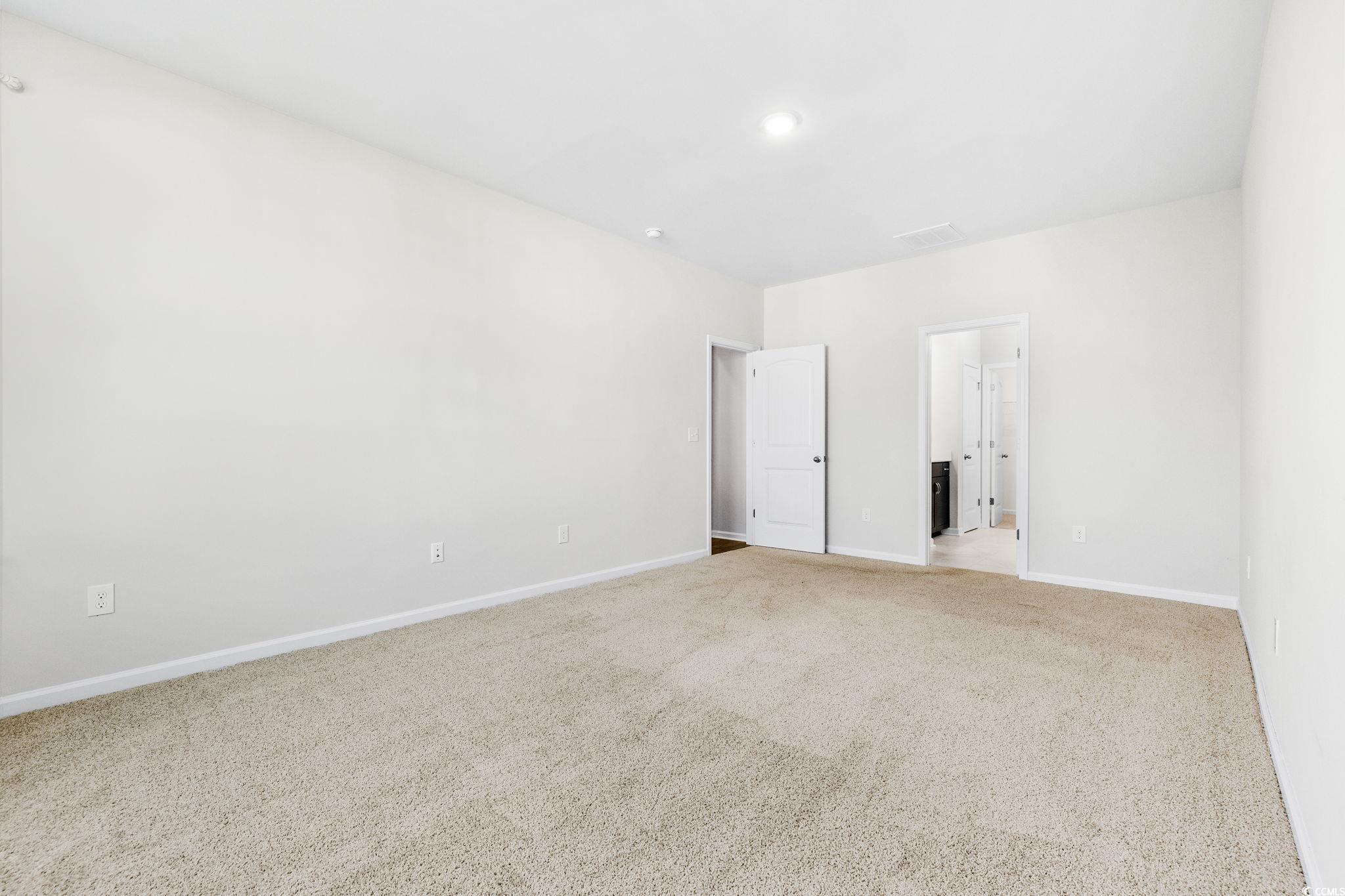 453 Kapalua Loop Little River, SC 29566 - Photo 19 of 27 Unfurnished bedroom featuring carpet flooring and ensuite bath