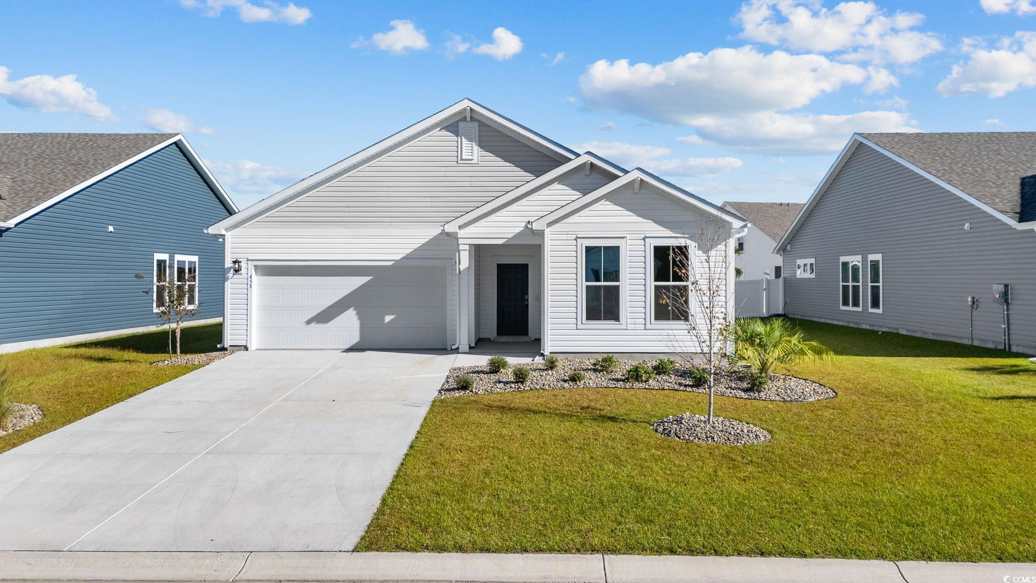 453 Kapalua Loop Little River, SC 29566 - Photo 2 of 27 View of front facade featuring driveway, a front lawn, and a garage