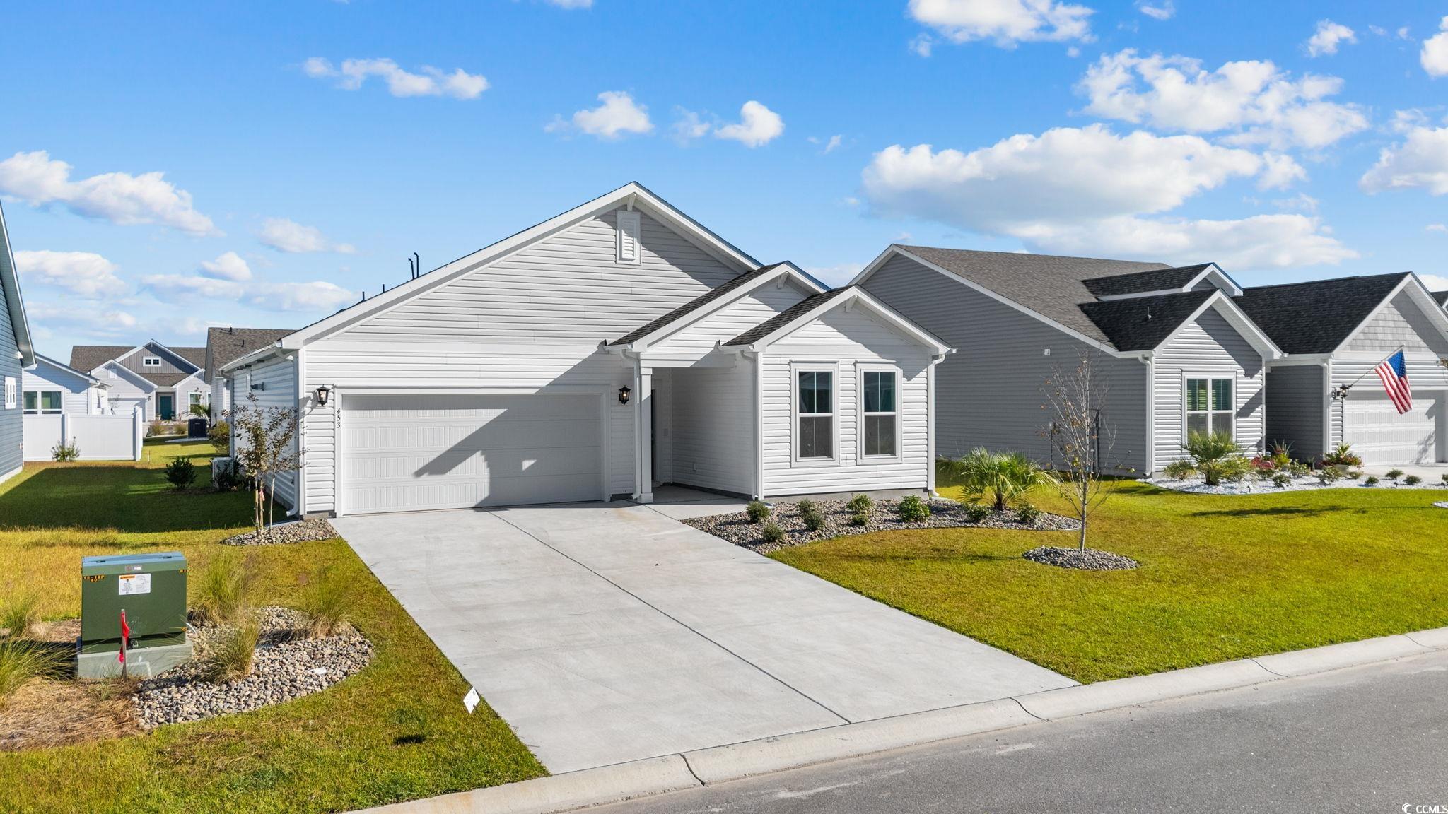 453 Kapalua Loop Little River, SC 29566 - Photo 3 of 27 View of front of house featuring a front lawn, driveway, and an attached garage