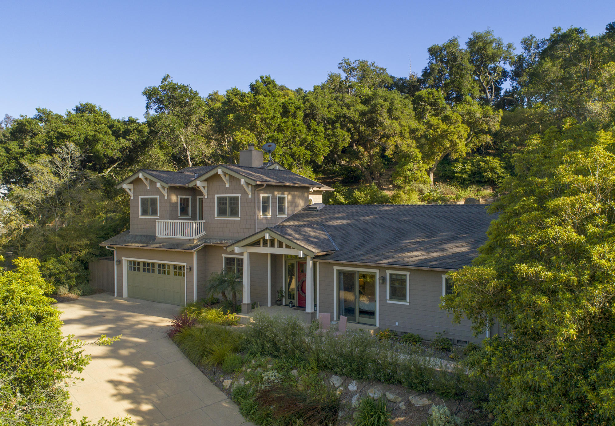 a front view of a house with a garden