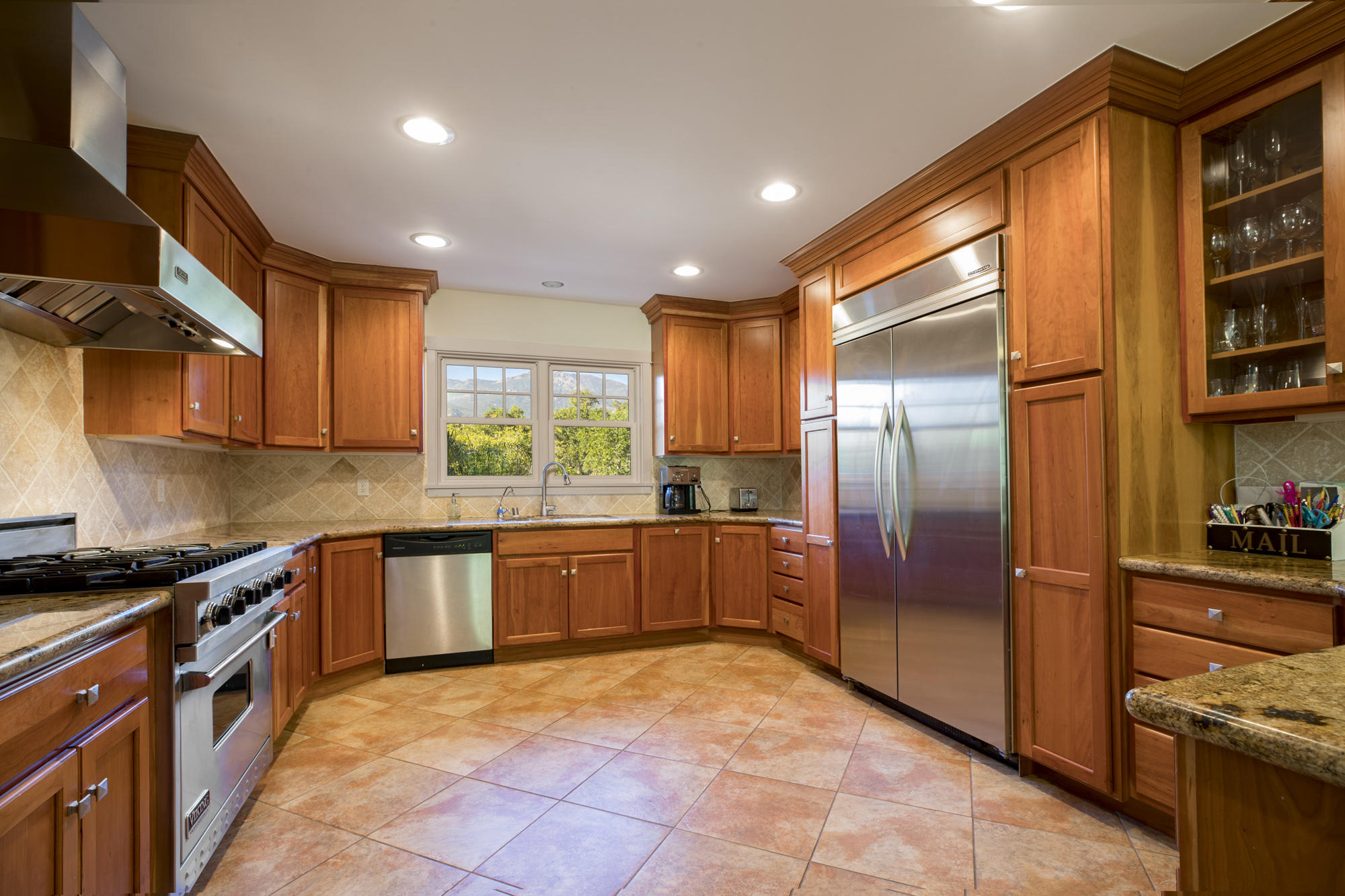 1006 Mission Ridge Road Santa Barbara, CA 93103 - Photo 4 of 21 a large kitchen with stainless steel appliances granite countertop a stove a sink and a refrigerator