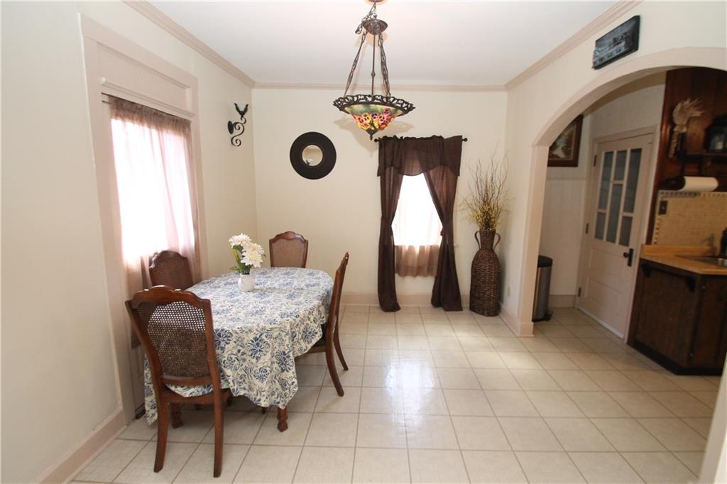 104 Sutherland Road Jeannette, PA 15644 - Photo 9 of 23 dining room with entrance into kitchen and door to the basement.