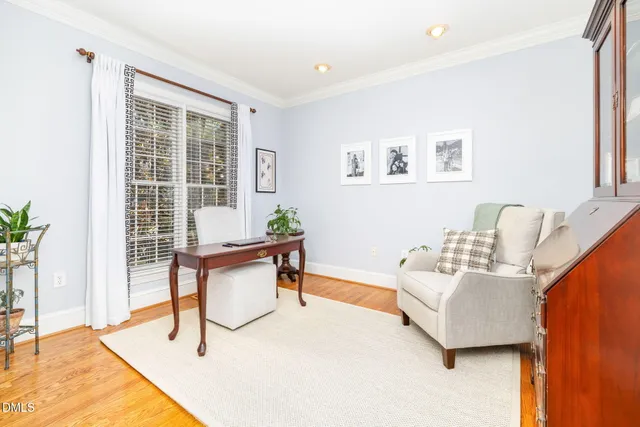 a view of a dining room with furniture and a chandelier