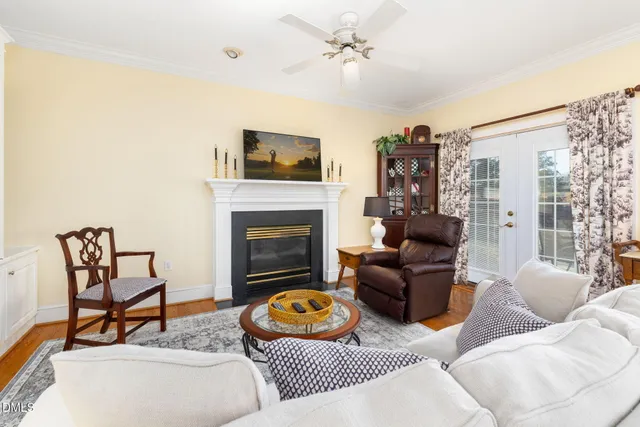 a kitchen with stainless steel appliances kitchen island granite countertop a stove top oven a sink a dining table and chairs with wooden floor