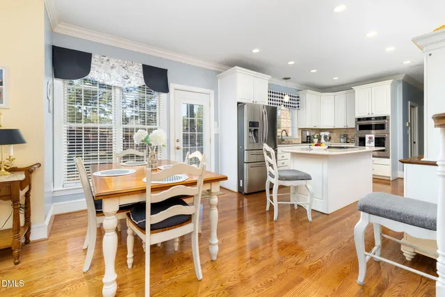 a kitchen with stainless steel appliances kitchen island granite countertop a refrigerator and a stove top oven