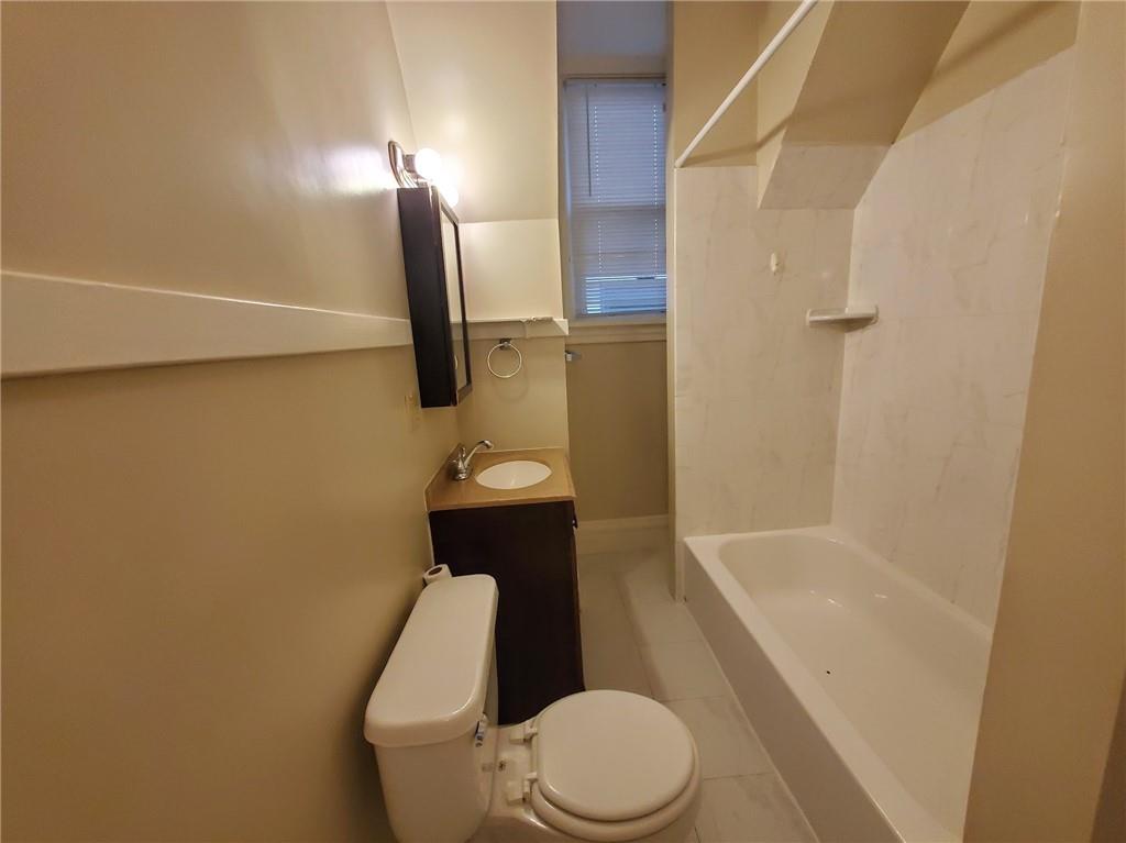 405 South Atlantic Avenue, Unit 3 Pittsburgh, PA 15224 - Photo 3 of 6 a white toilet sitting next to a bath tub