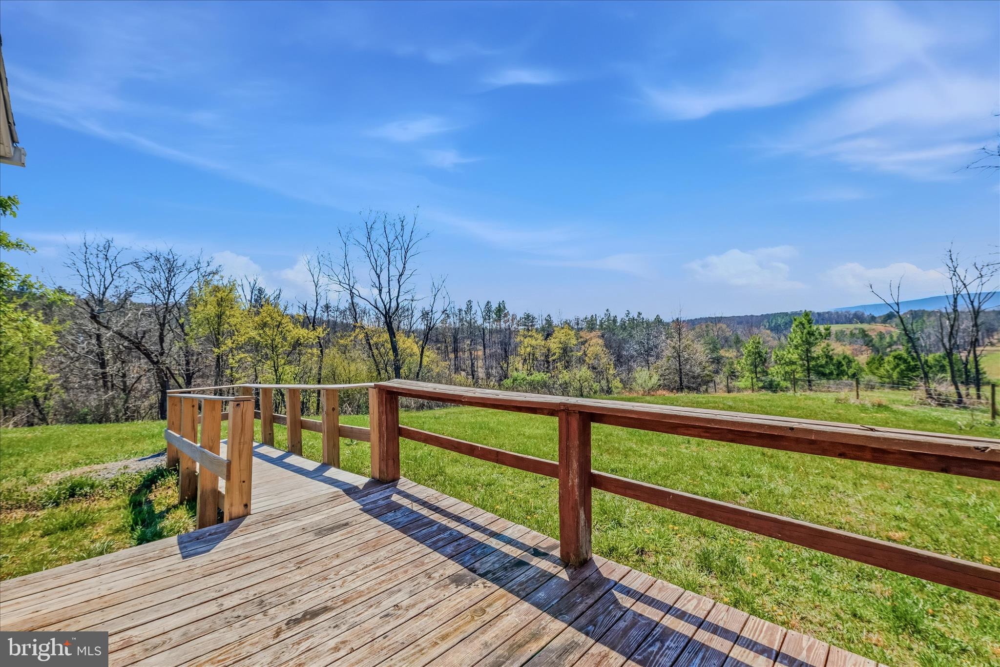 1420 Eppinger Road Berkeley Springs, WV 25411 - Photo 1 of 1 a view of a balcony with wooden floor & fence