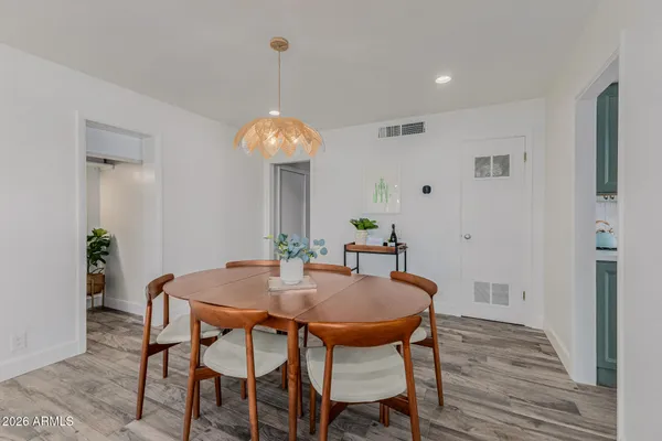 a view of a dining room with furniture and wooden floor