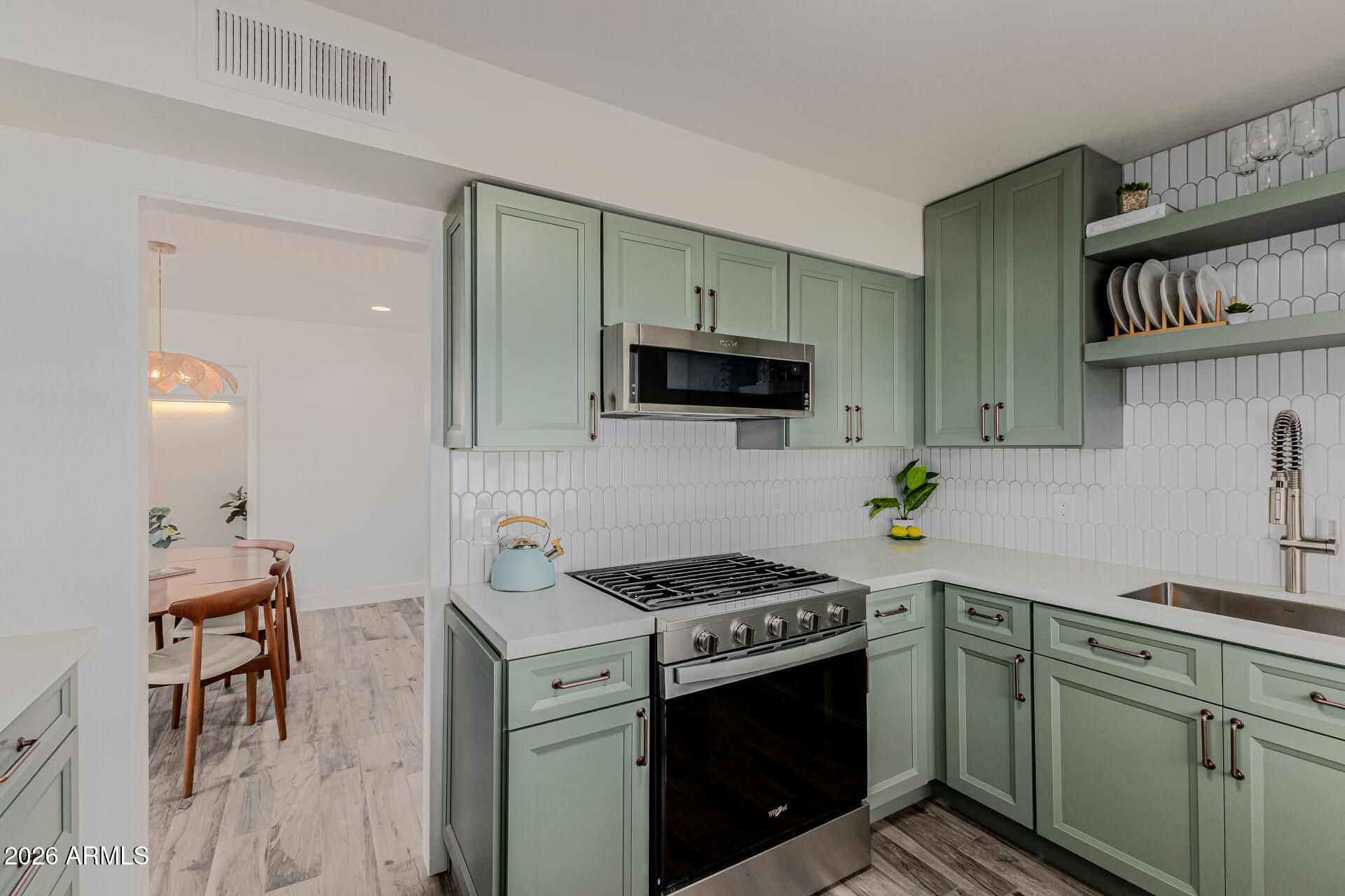 160 East Coronado Road, Unit 58 Phoenix, AZ 85004 - Photo 12 of 50 a kitchen with stainless steel appliances a stove a sink a microwave a refrigerator and cabinets