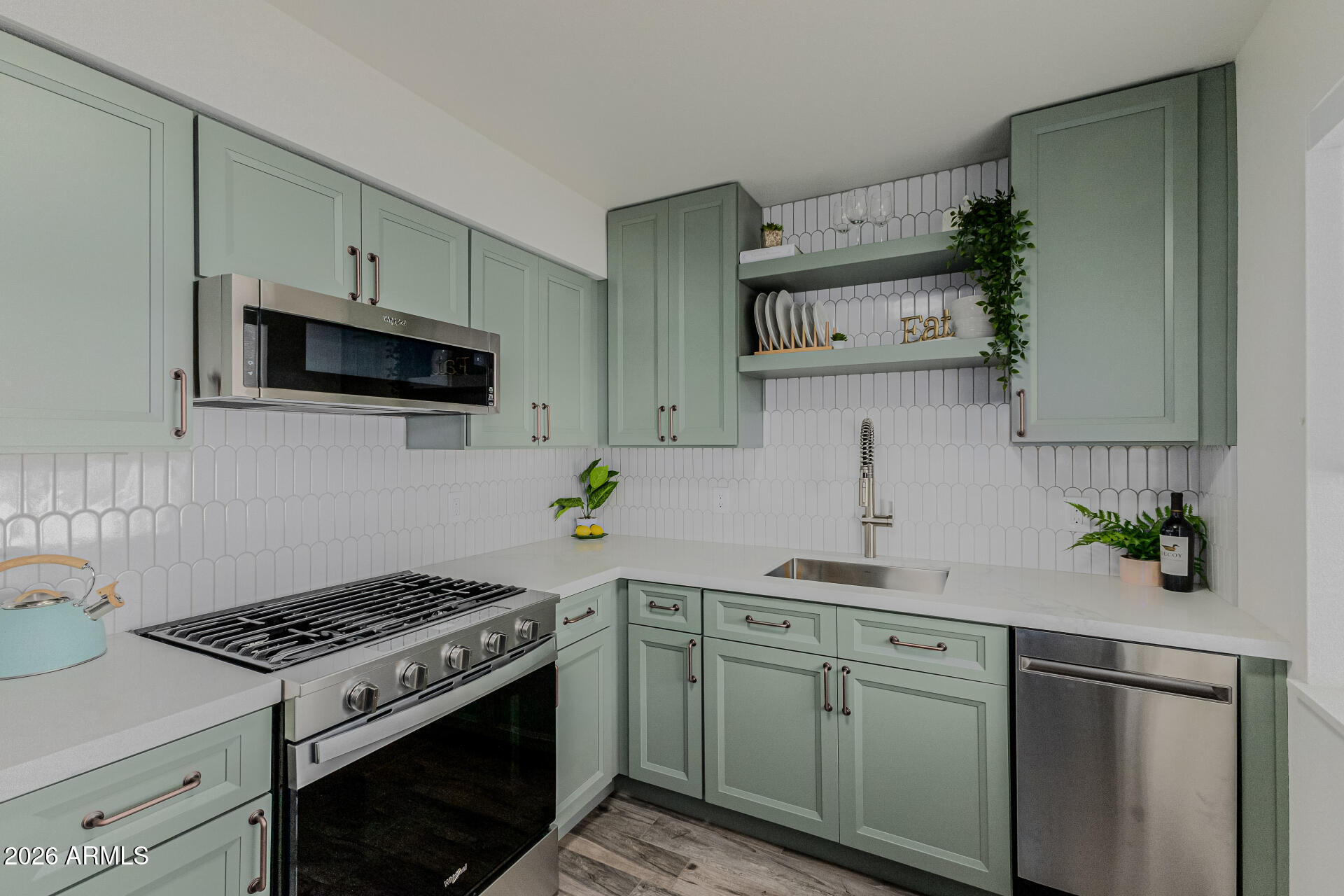 160 East Coronado Road, Unit 58 Phoenix, AZ 85004 - Photo 13 of 50 a kitchen with cabinets stainless steel appliances and a wooden floor