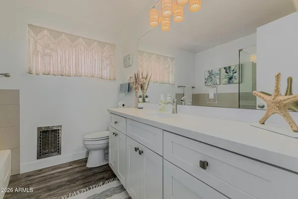 a bathroom with a sink a toilet and a mirror