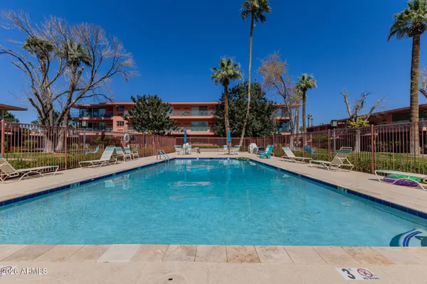 a swimming pool view with a outdoor seating