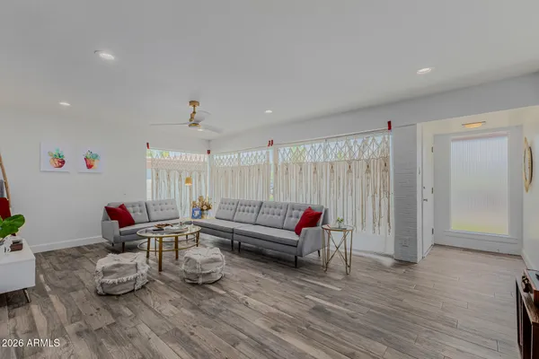 a living room with furniture and wooden floor