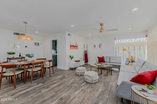 a room with furniture a wooden floor and a chandelier