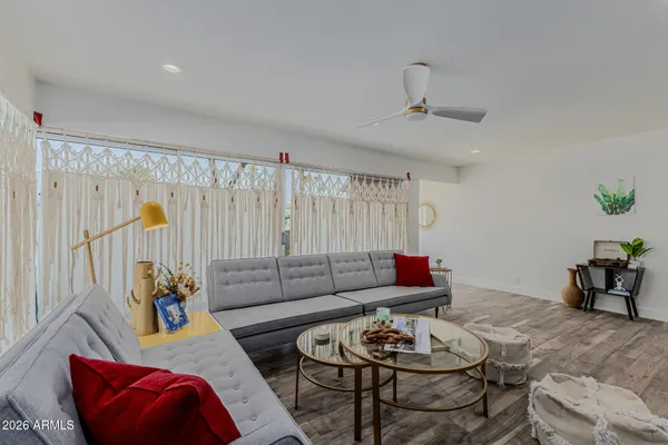 a living room with furniture and wooden floor