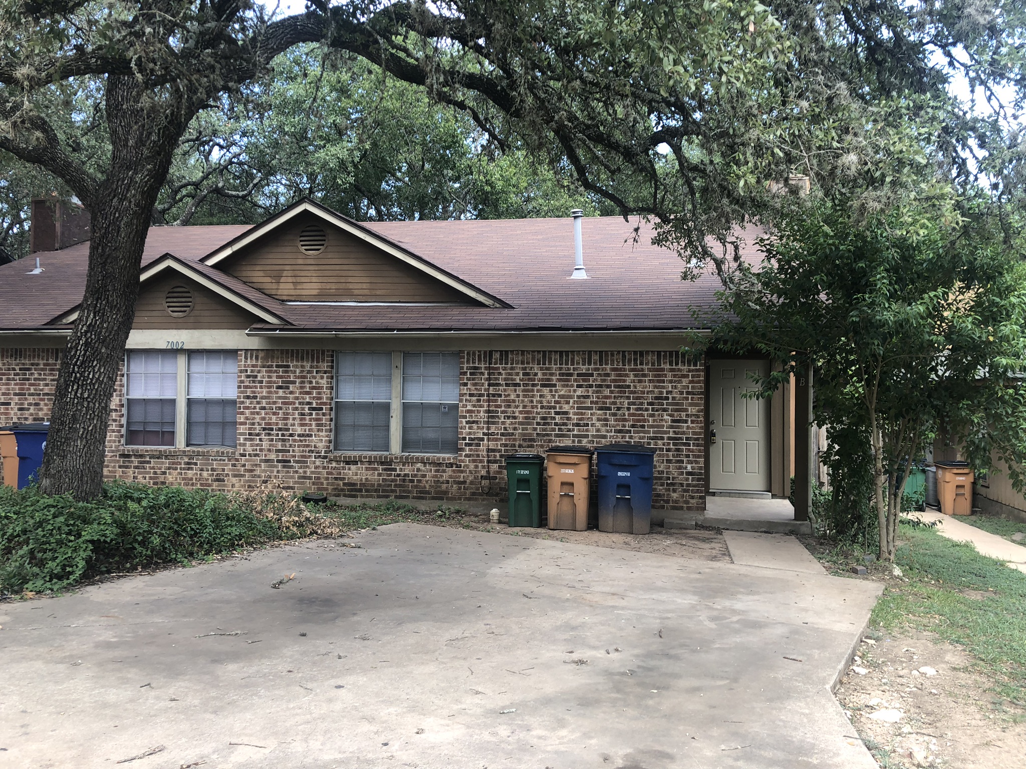 7002 Ivory Key Court, Unit B Austin, TX 78745 - Photo 1 of 1 View of front of home featuring a shingled roof and brick siding