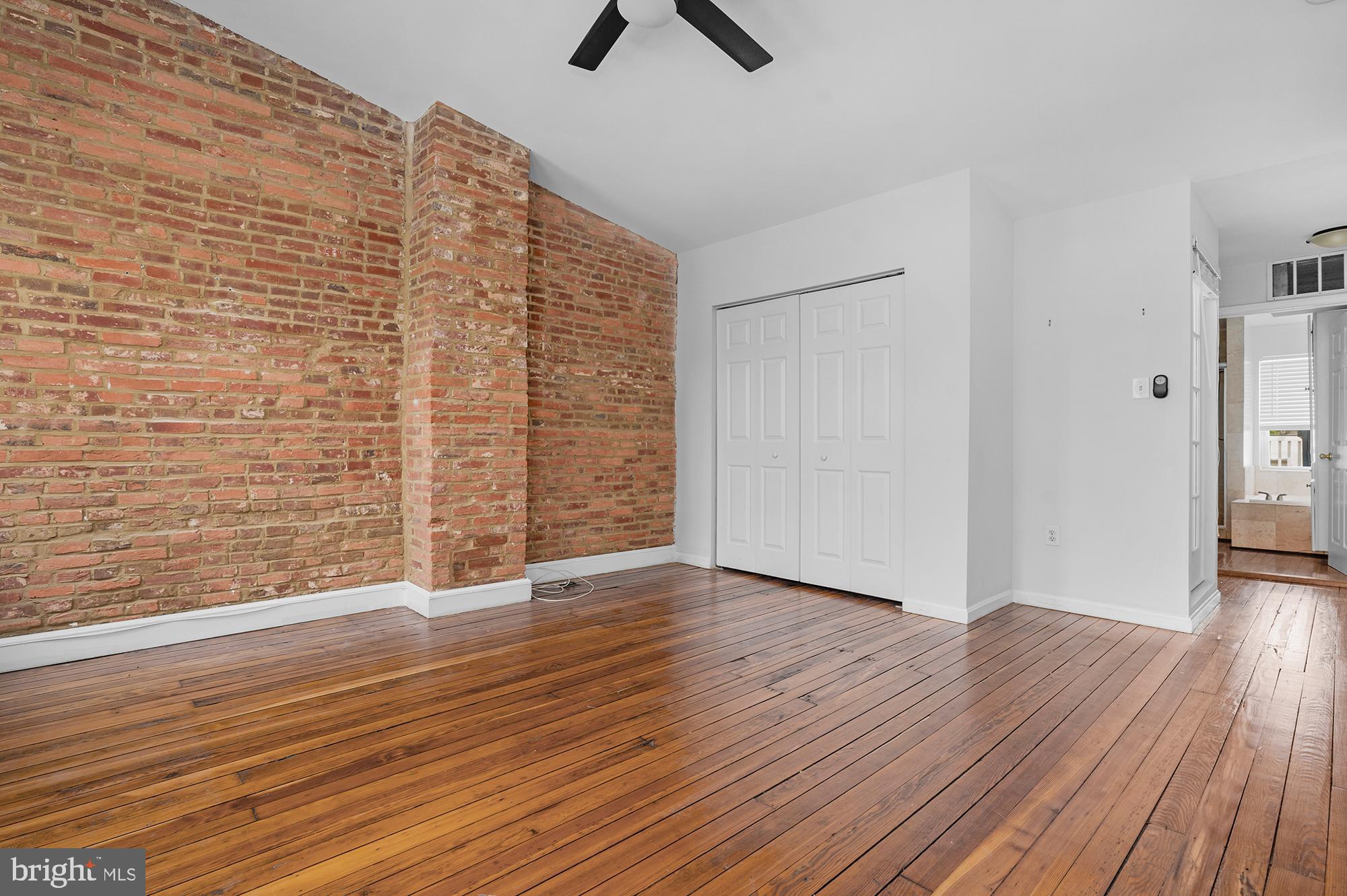 1329 South Charles Street Baltimore, MD 21230 - Photo 14 of 30 wooden floor in an empty room with a window