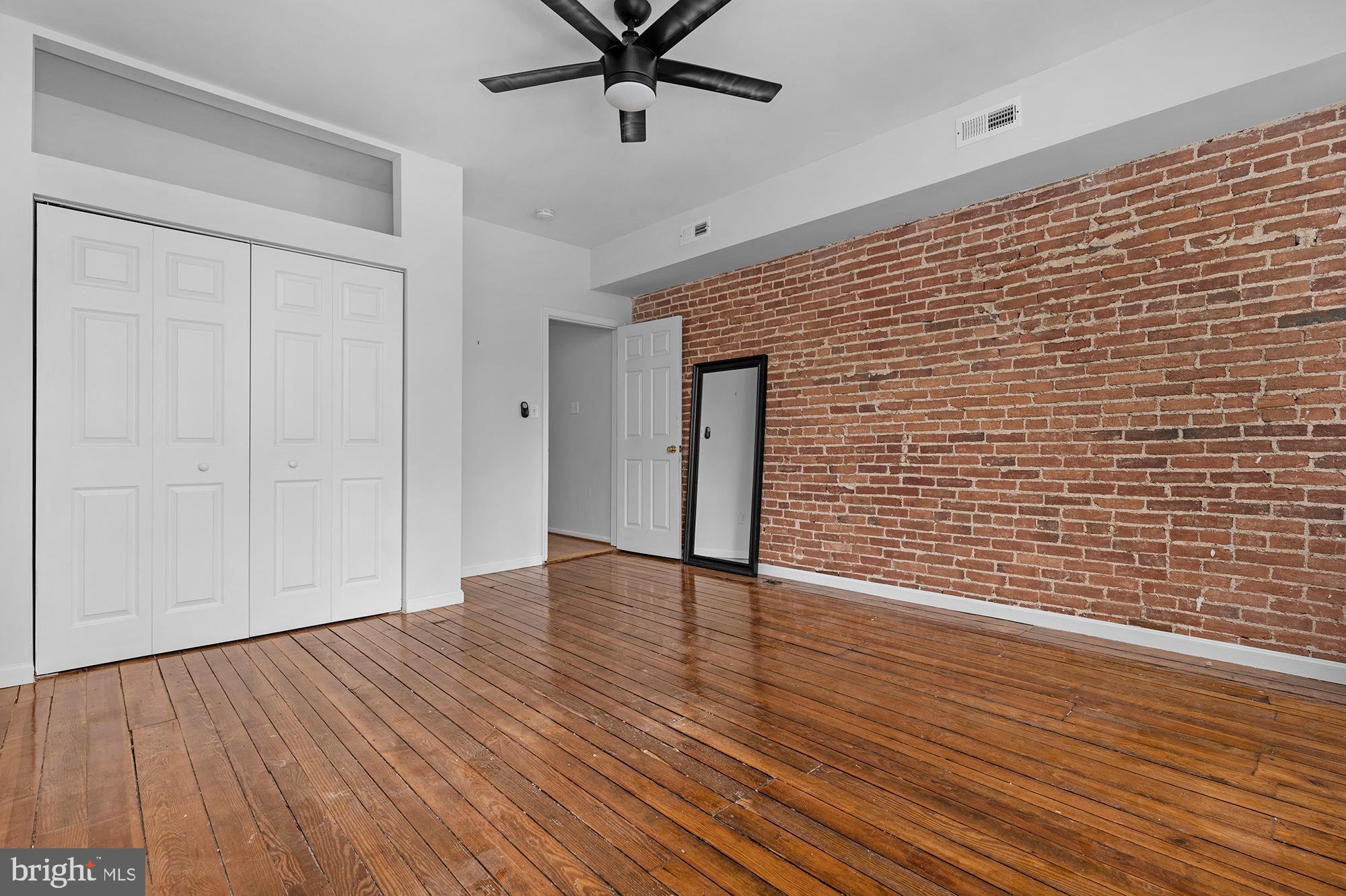 1329 South Charles Street Baltimore, MD 21230 - Photo 18 of 30 a view of an empty room with wooden floor