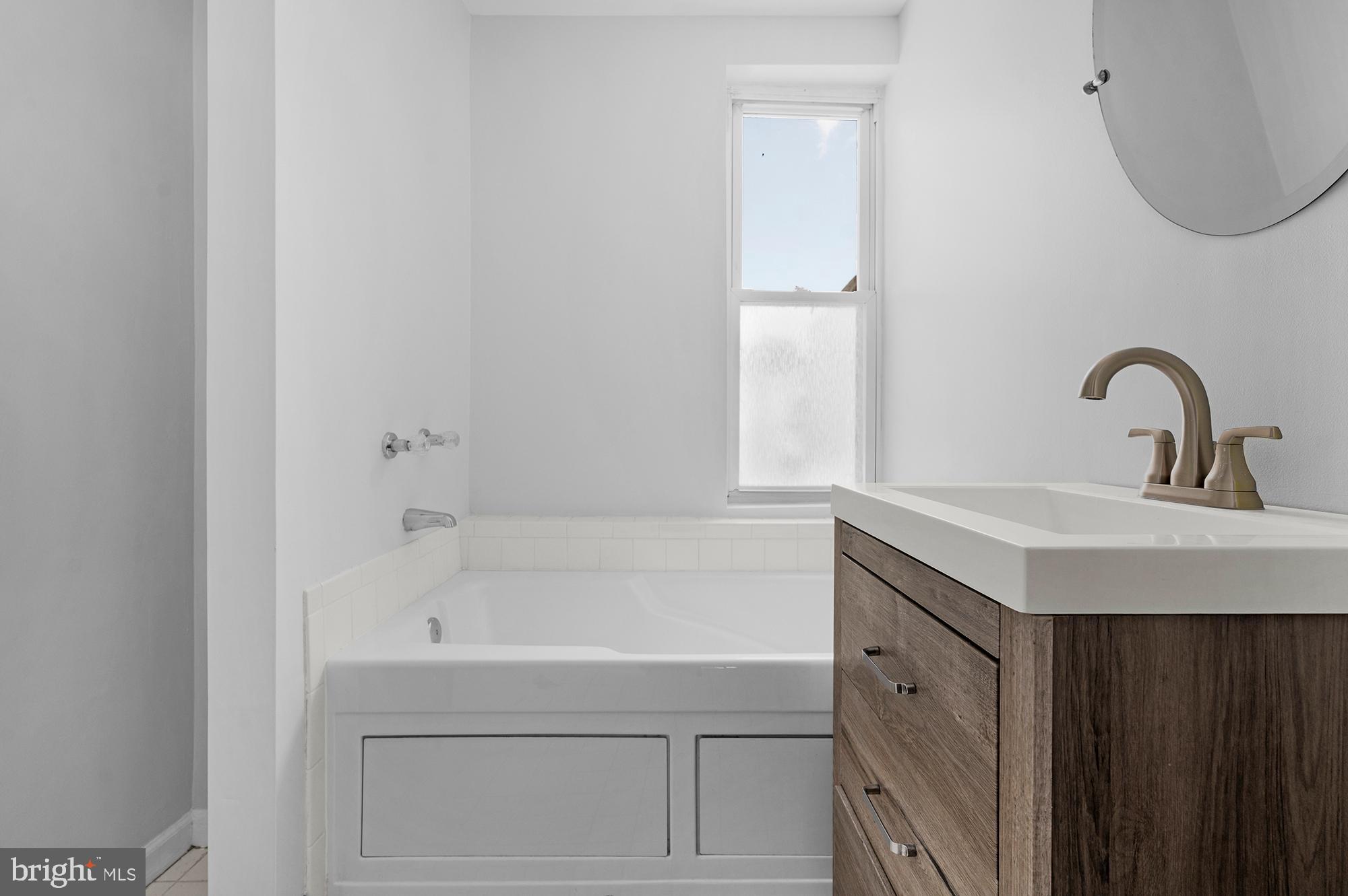 1329 South Charles Street Baltimore, MD 21230 - Photo 19 of 30 a bathroom with a sink and a bathtub