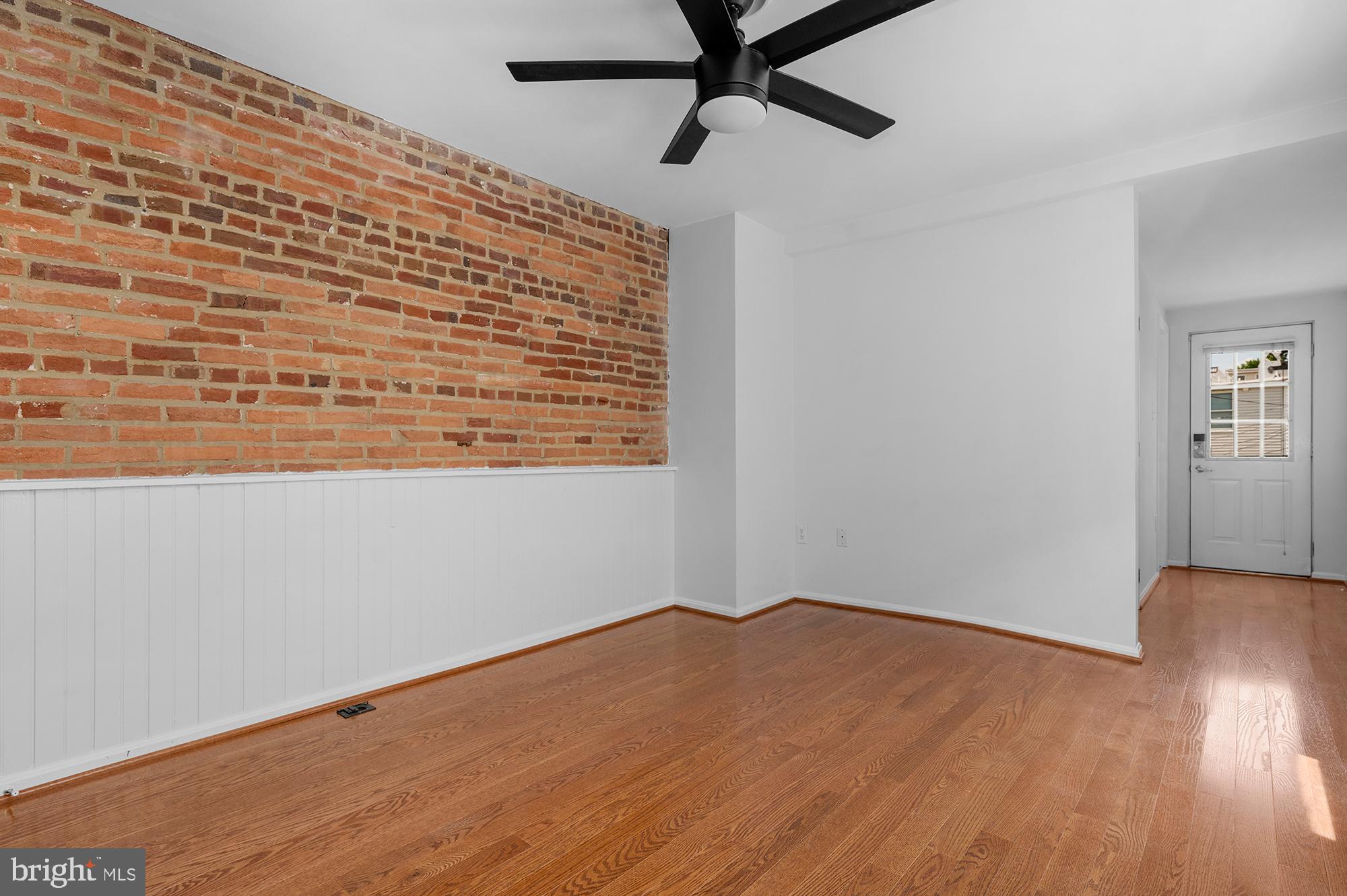 1329 South Charles Street Baltimore, MD 21230 - Photo 21 of 30 a view of an empty room with wooden floor