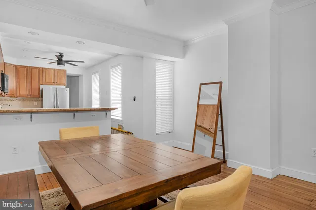 a room with a table chairs and wooden floor