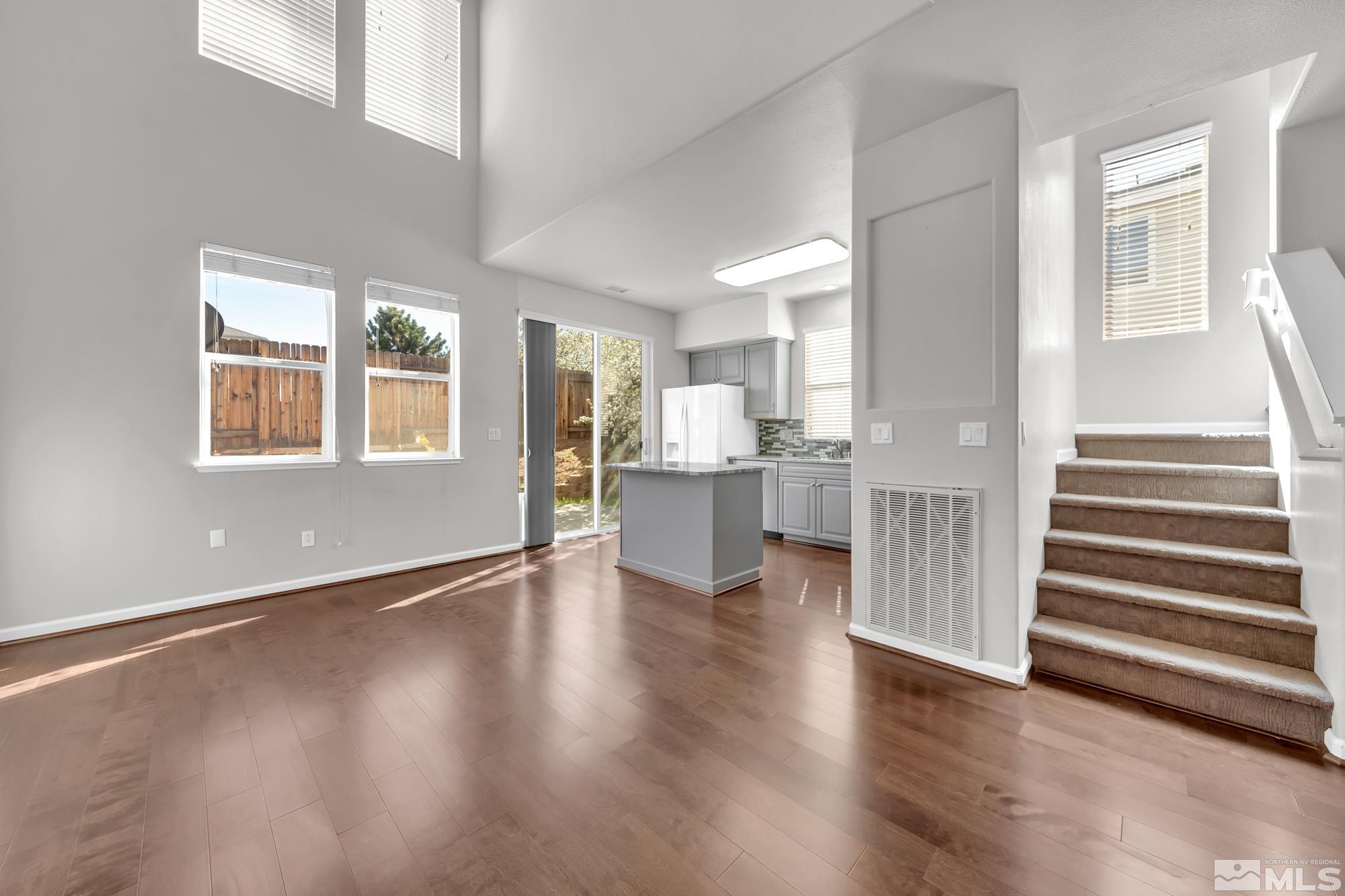 9266 Running Dog Circle Reno, NV 89506 - Photo 13 of 35 an empty room with wooden floor and windows