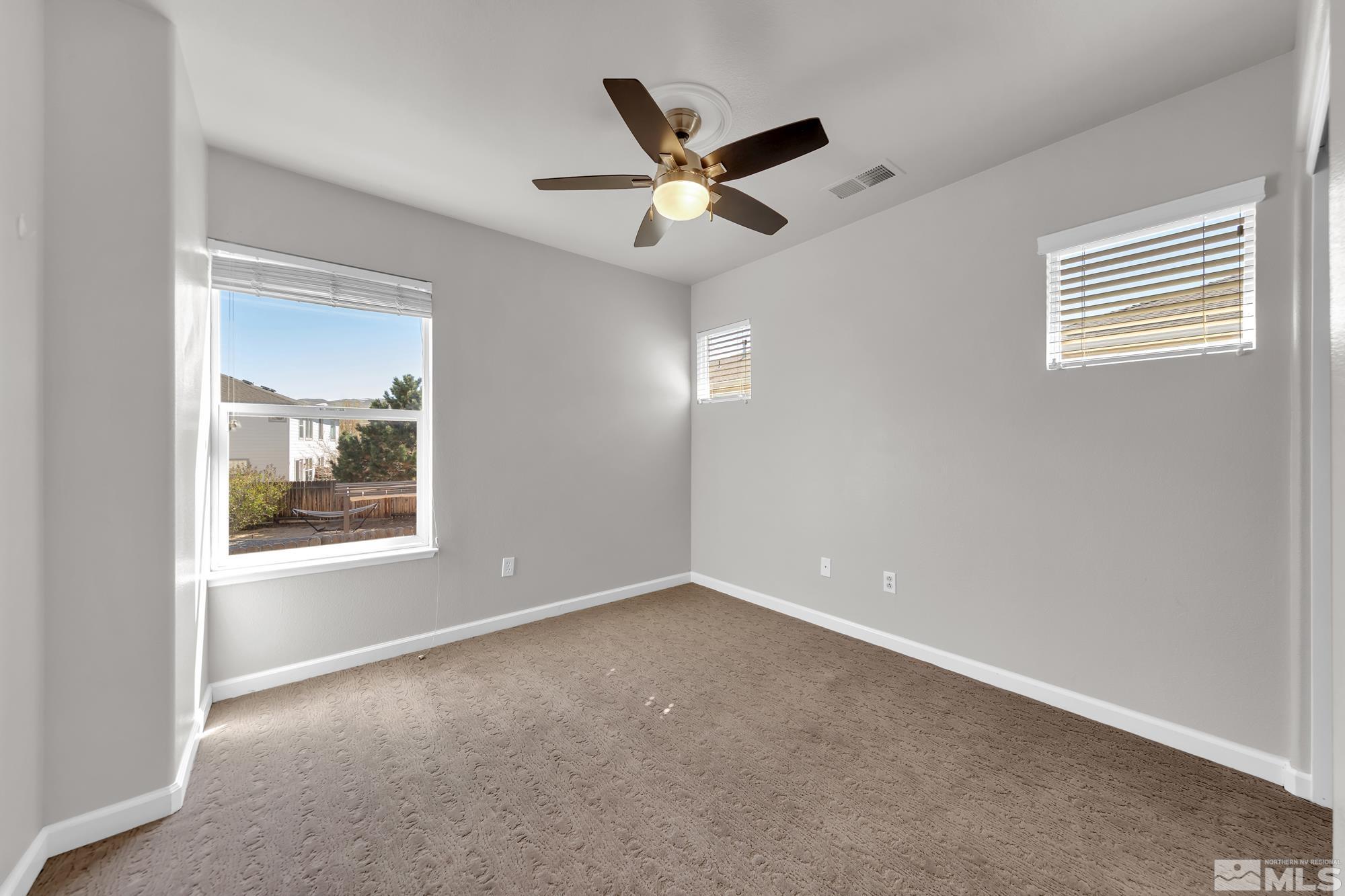 9266 Running Dog Circle Reno, NV 89506 - Photo 18 of 35 an empty room with a window and a ceiling fan