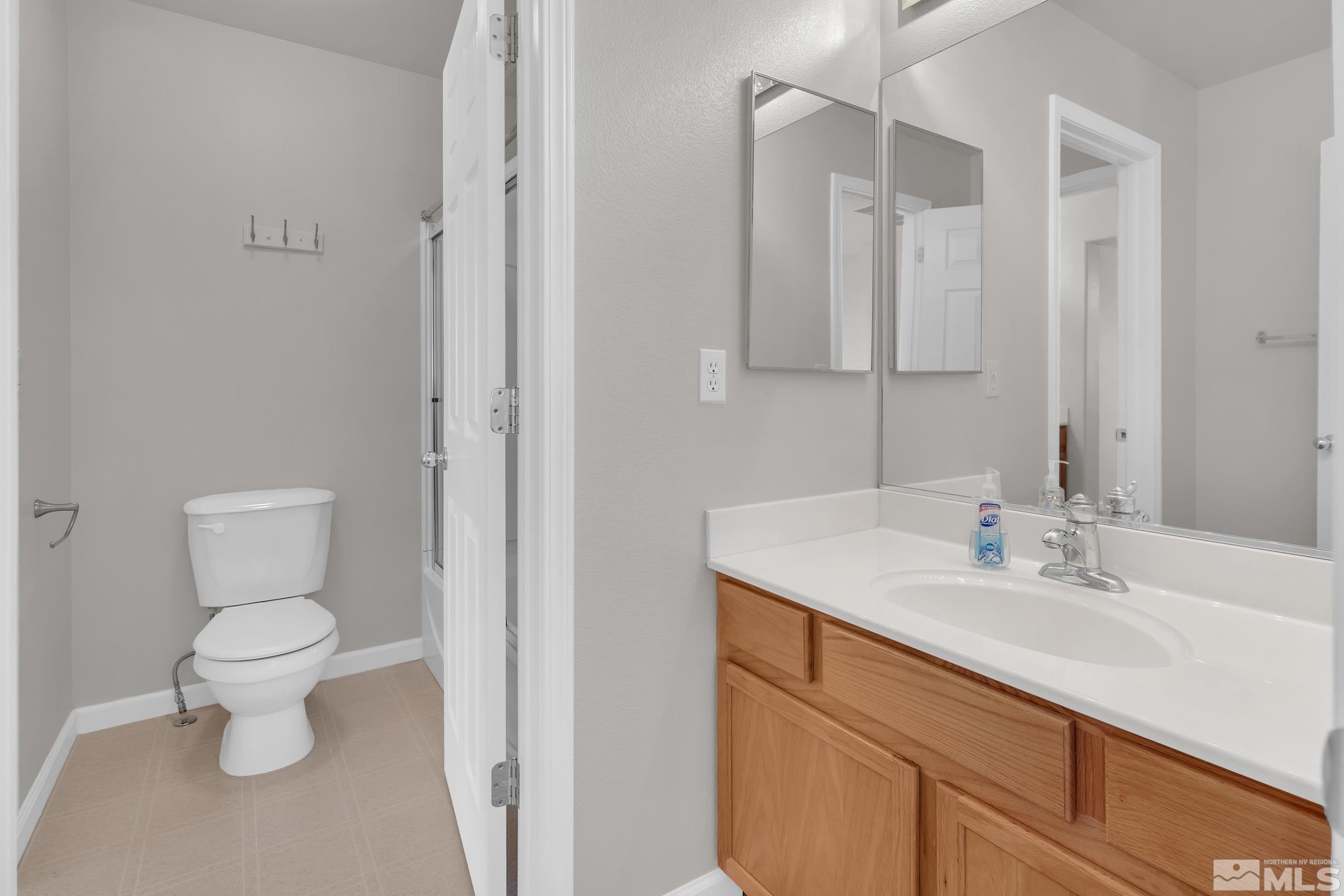 9266 Running Dog Circle Reno, NV 89506 - Photo 19 of 35 a bathroom with a sink toilet and shower