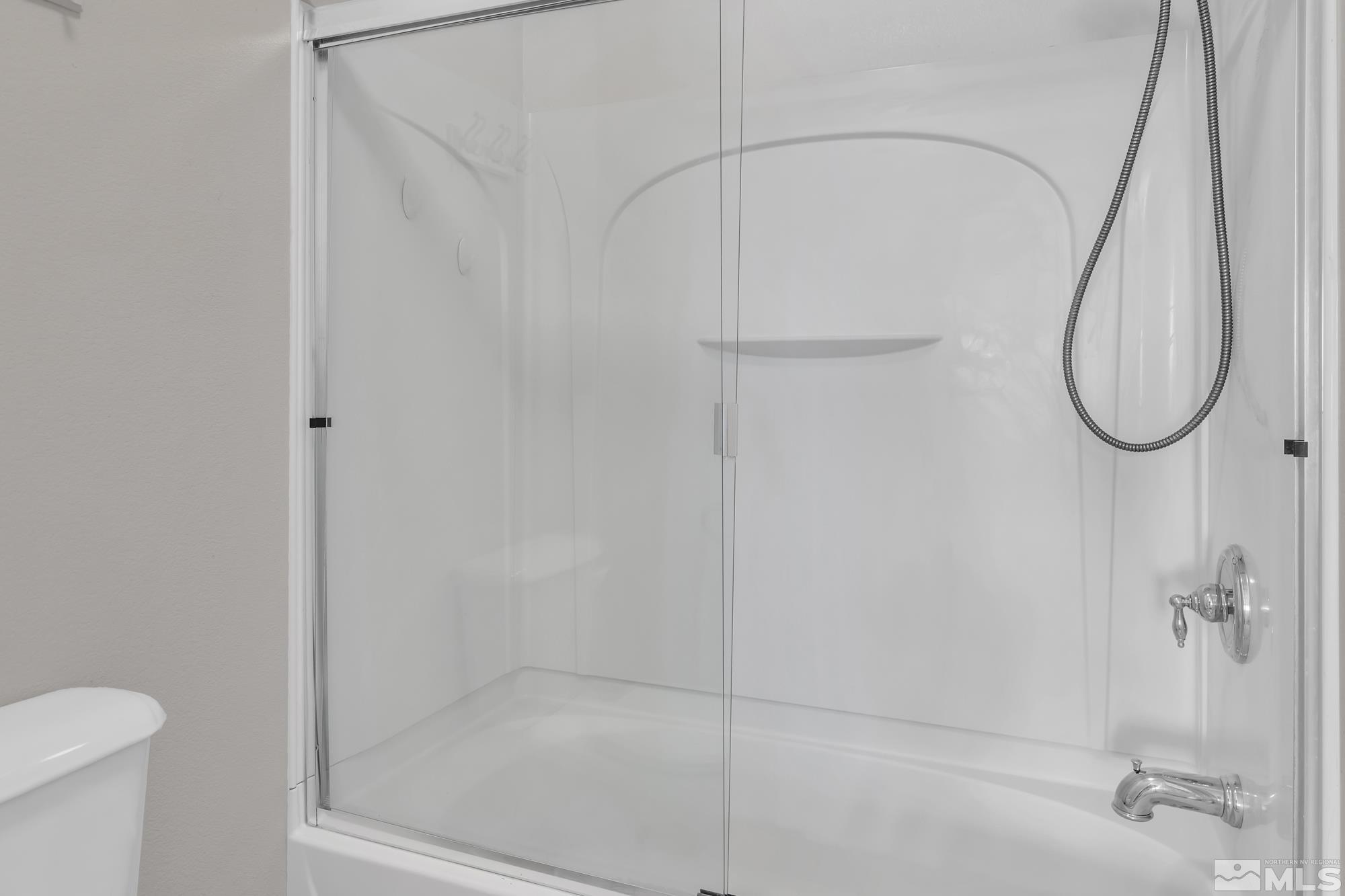 9266 Running Dog Circle Reno, NV 89506 - Photo 20 of 35 a bathroom with a glass shower door