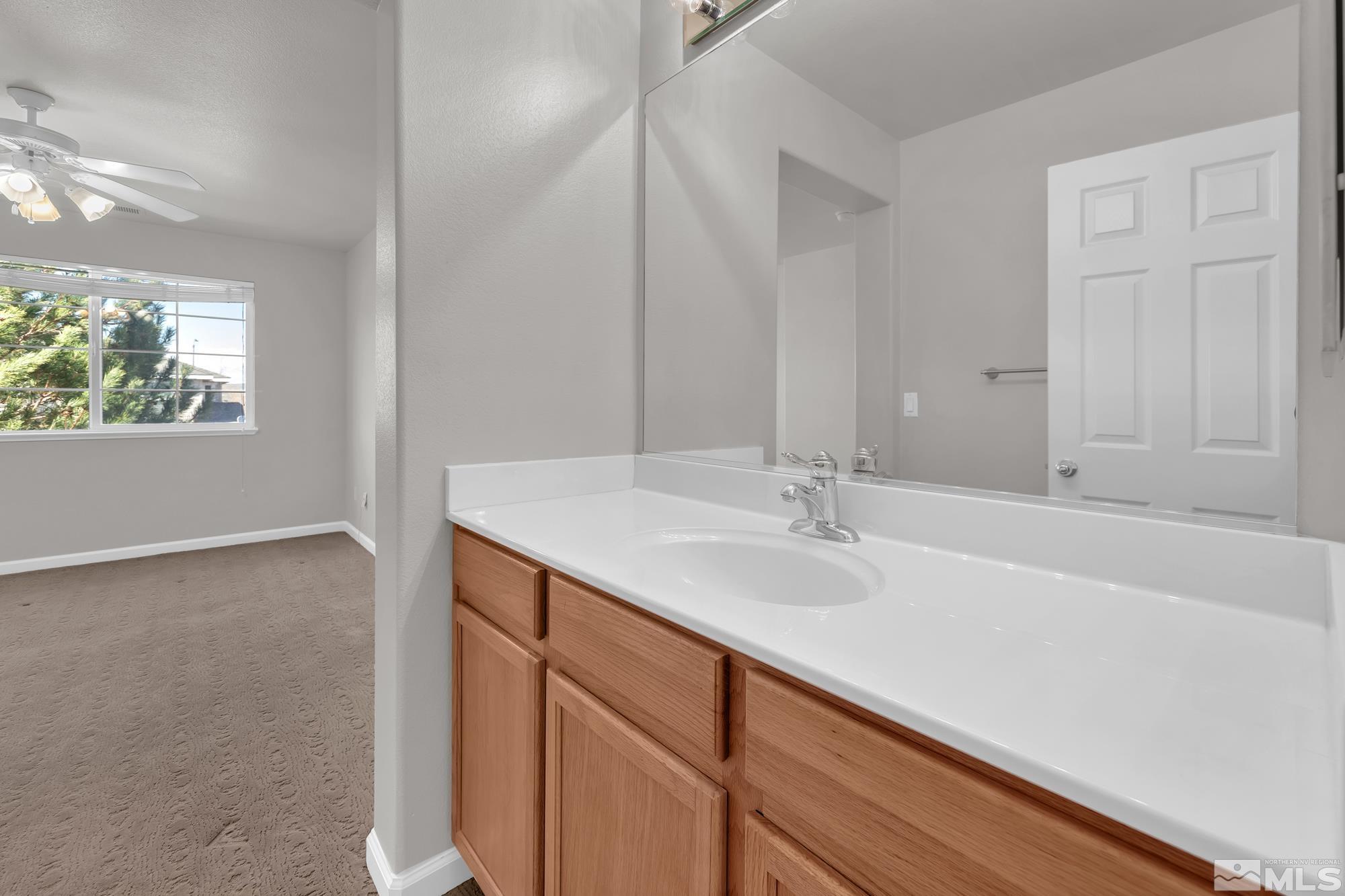 9266 Running Dog Circle Reno, NV 89506 - Photo 21 of 35 a bathroom with a sink and a large mirror
