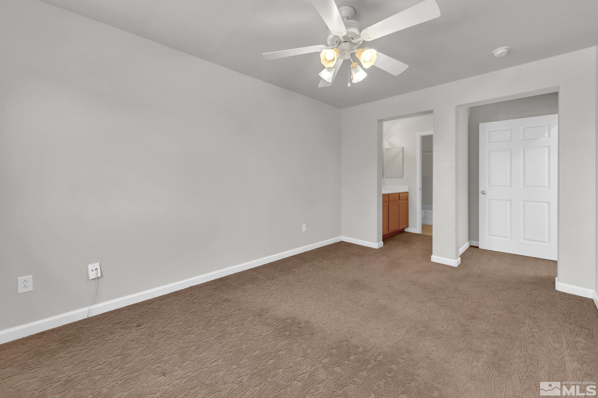 9266 Running Dog Circle Reno, NV 89506 - Photo 25 of 35 an empty room with closet and a ceiling fan