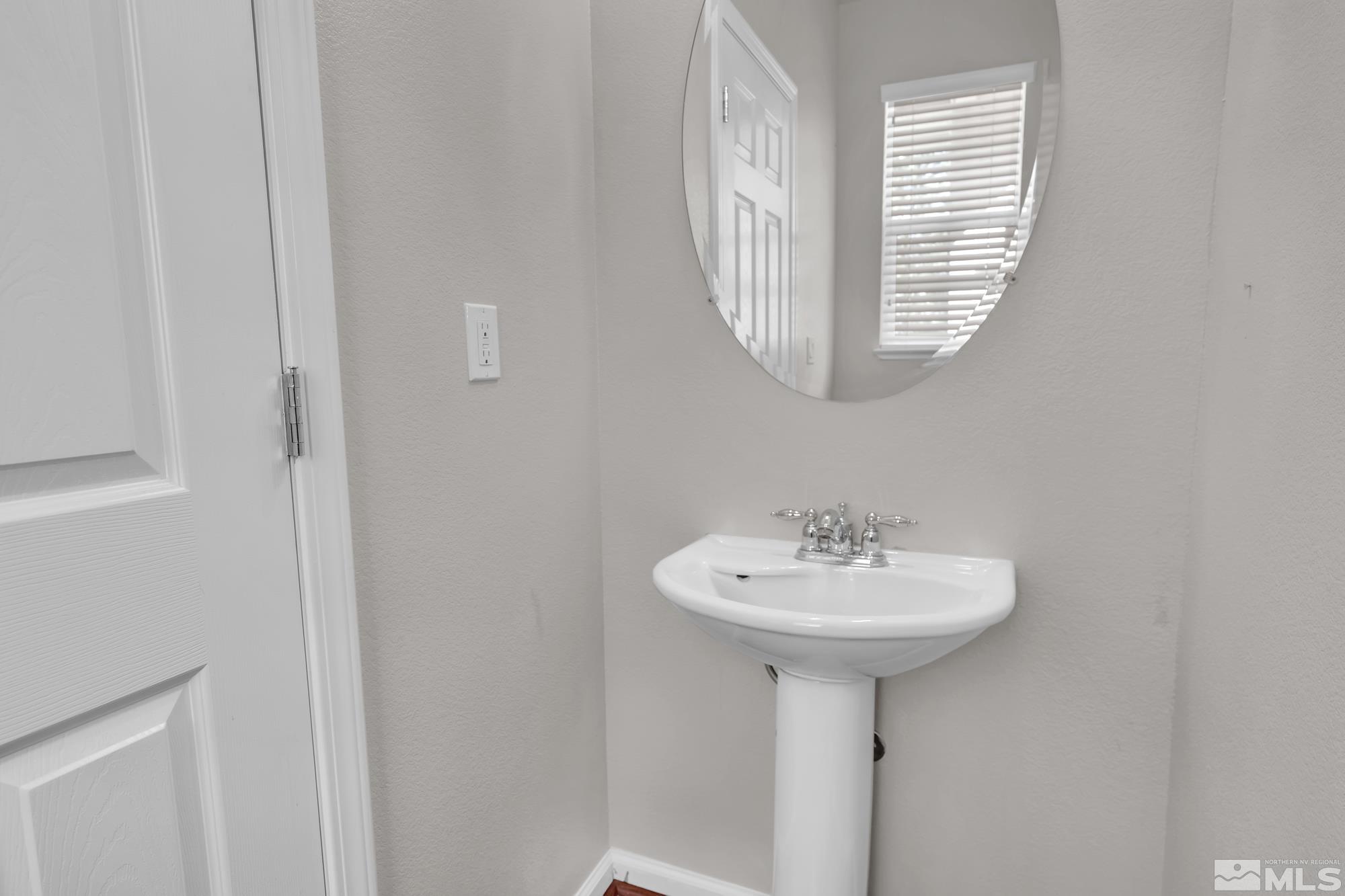 9266 Running Dog Circle Reno, NV 89506 - Photo 29 of 35 a bathroom with a sink a mirror and a window