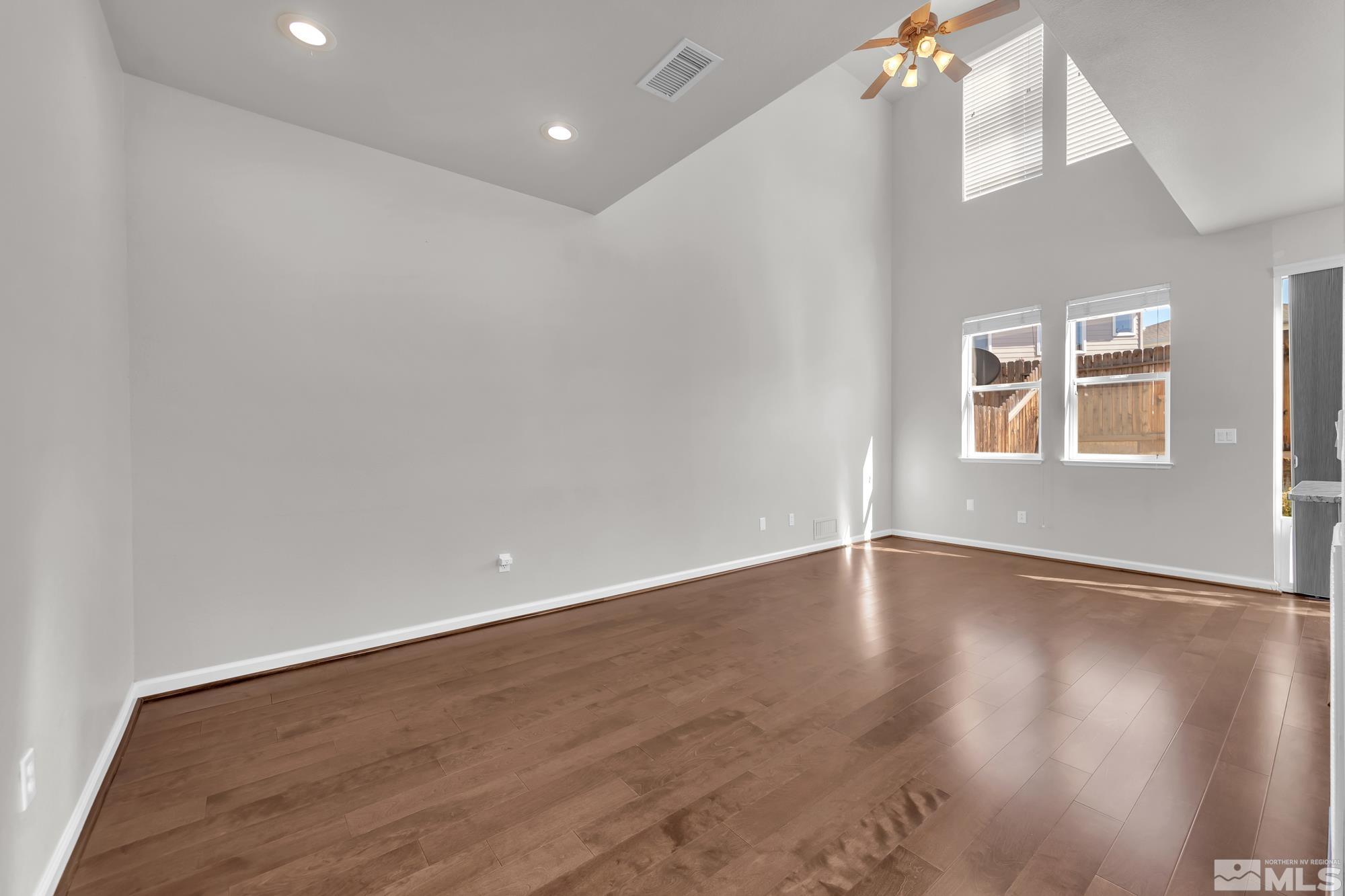 9266 Running Dog Circle Reno, NV 89506 - Photo 6 of 35 a view of an empty room with wooden floor and a window