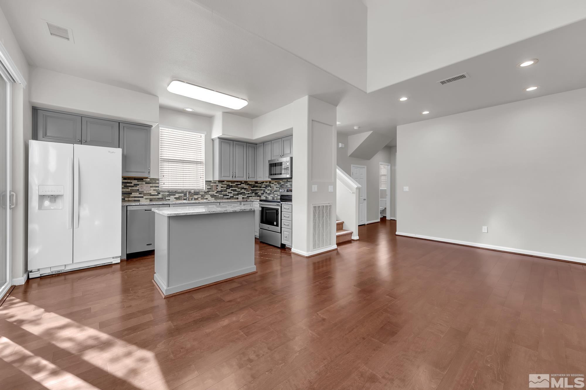 9266 Running Dog Circle Reno, NV 89506 - Photo 8 of 35 a view of kitchen with refrigerator and wooden floor