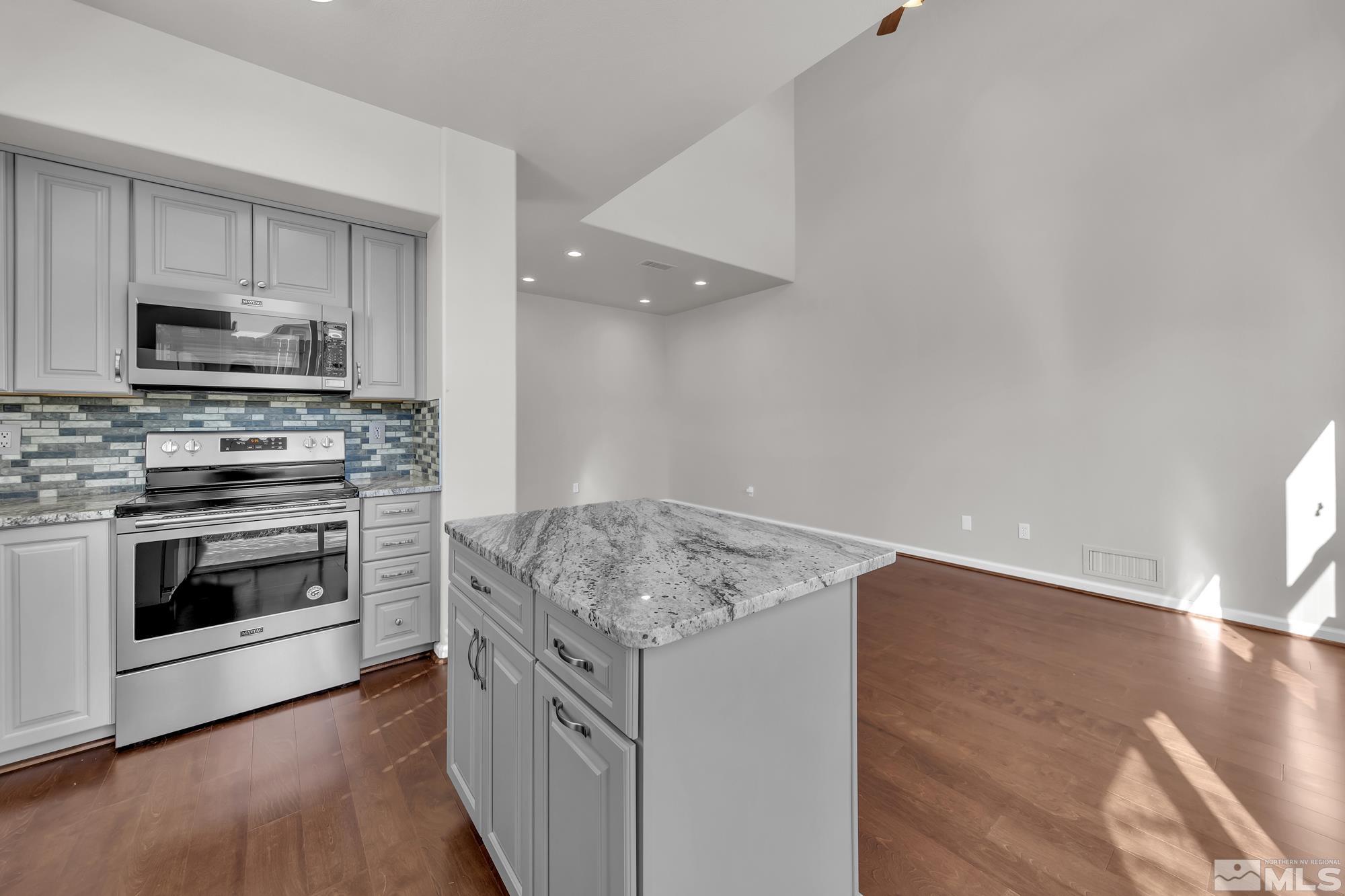 9266 Running Dog Circle Reno, NV 89506 - Photo 10 of 35 a kitchen with a stove and a microwave