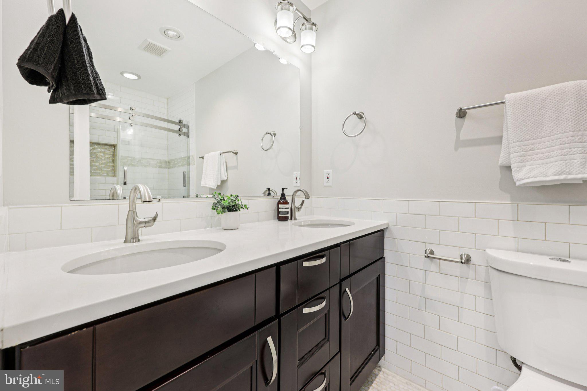 5209 5th Street Northwest Washington, DC 20011 - Photo 17 of 38 a bathroom with a sink and a mirror