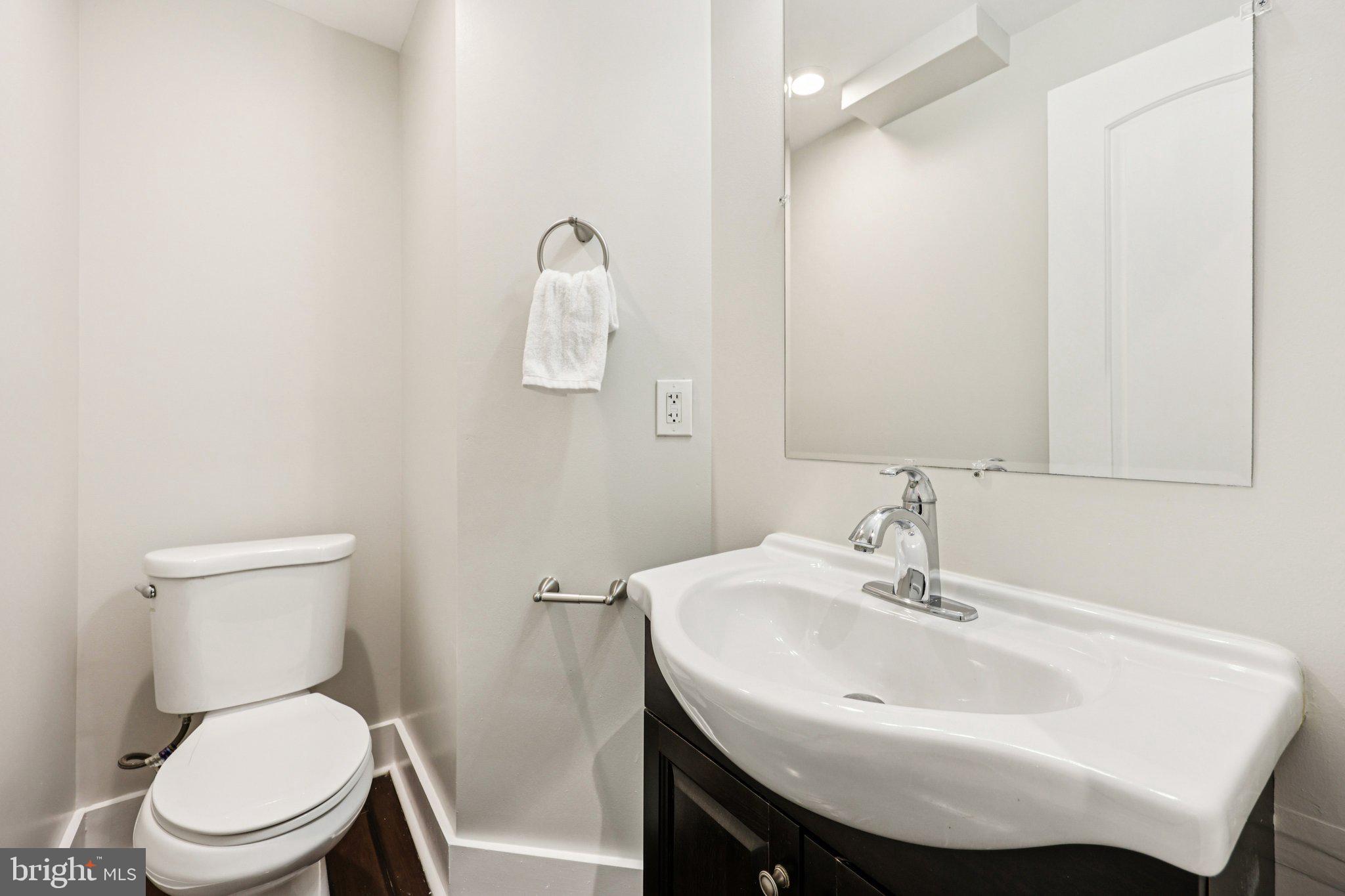 5209 5th Street Northwest Washington, DC 20011 - Photo 10 of 38 a bathroom with a sink a toilet and a mirror