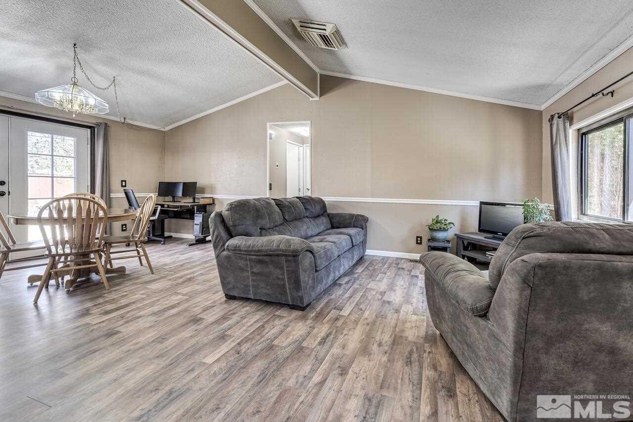 17625 Macaw Lane Reno, NV 89508 - Photo 8 of 40 a living room with furniture and a chandelier