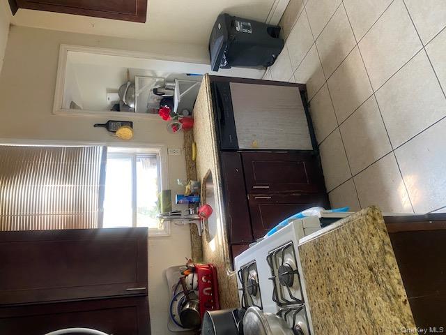 91-07 139th Street Queens, NY 11435 - Photo 11 of 12 a kitchen with a sink stove and cabinets