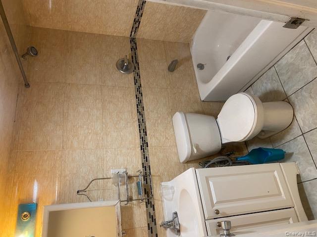 91-07 139th Street Queens, NY 11435 - Photo 3 of 12 a bathroom with a sink a toilet and bathtub