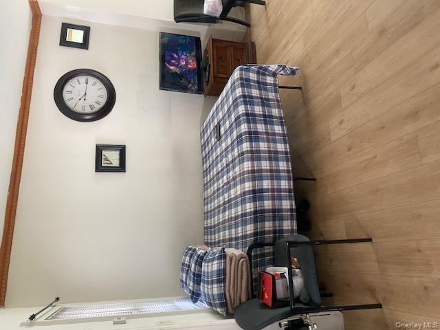 91-07 139th Street Queens, NY 11435 - Photo 9 of 12 a bedroom with a bed and a chair