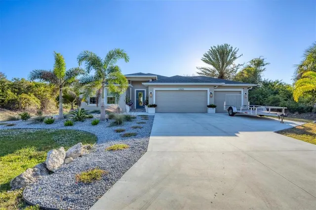 a view of a house with backyard porch and sitting area