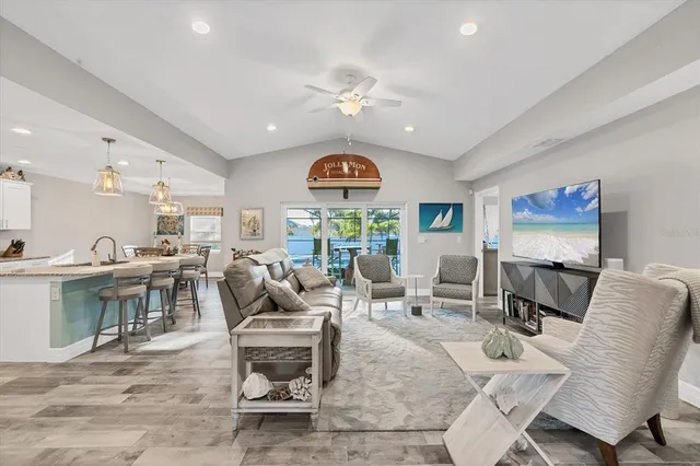 a living room with furniture a rug and a flat screen tv