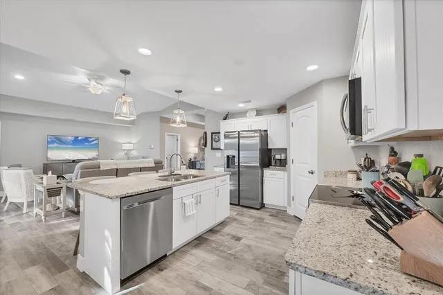 a kitchen with stainless steel appliances granite countertop a stove oven and a refrigerator