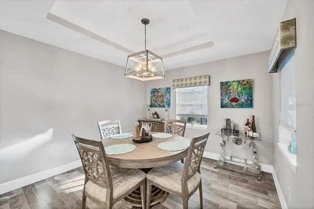 a view of a dining room with furniture wooden floor and chandelier