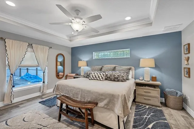 a bedroom with a bed and wooden floor