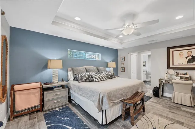 a bedroom with a large bed and a chandelier