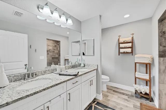 a bedroom with a bed and a table in it with window