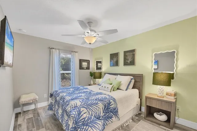 a bedroom with a large bed and a chandelier